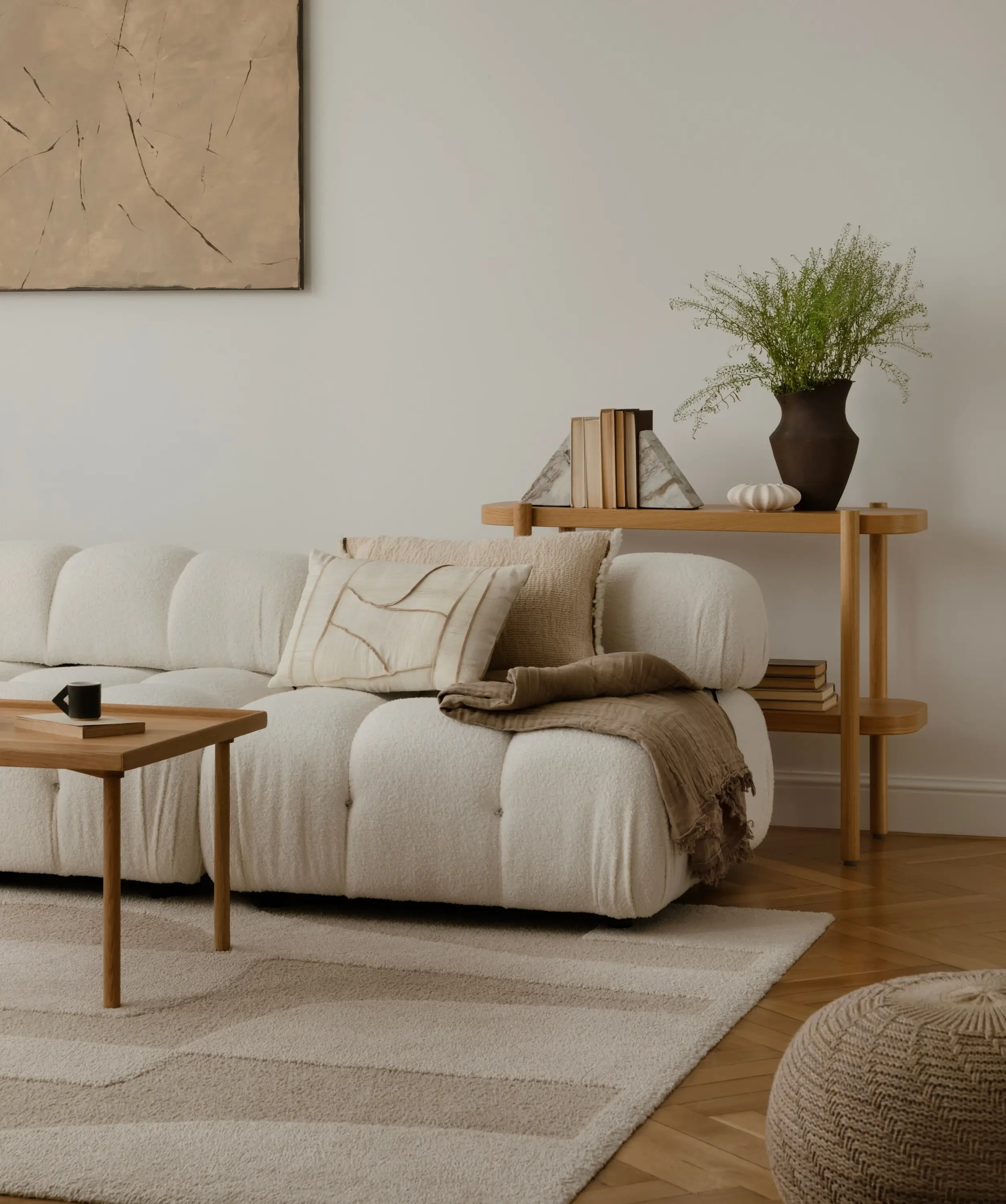 Helles Wohnzimmer mit cremefarbenem Sofa, Kissen und natürlicher Deko.